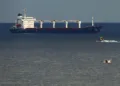 A boat with Russian, Ukrainian, Turkish and U.N. officials heads to the Sierra Leone-flagged cargo ship Razoni, to check if the grain shipment is in accordance with a crucial agreement signed last month by Moscow and Kyiv, at an inspection area in the Black Sea off the coast of Istanbul, Türkiye, Aug. 3, 2022. (AP Photo)