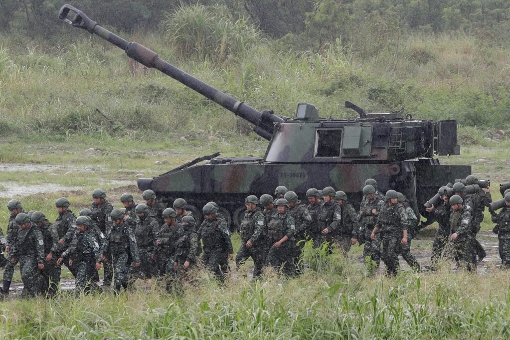 Soldados pasan junto a un obús autopropulsado durante un entrenamiento militar de tiro real en Taichung City, Taiwán, el martes 9 de junio de 2026. (Foto AP/Chiang Ying-ying)