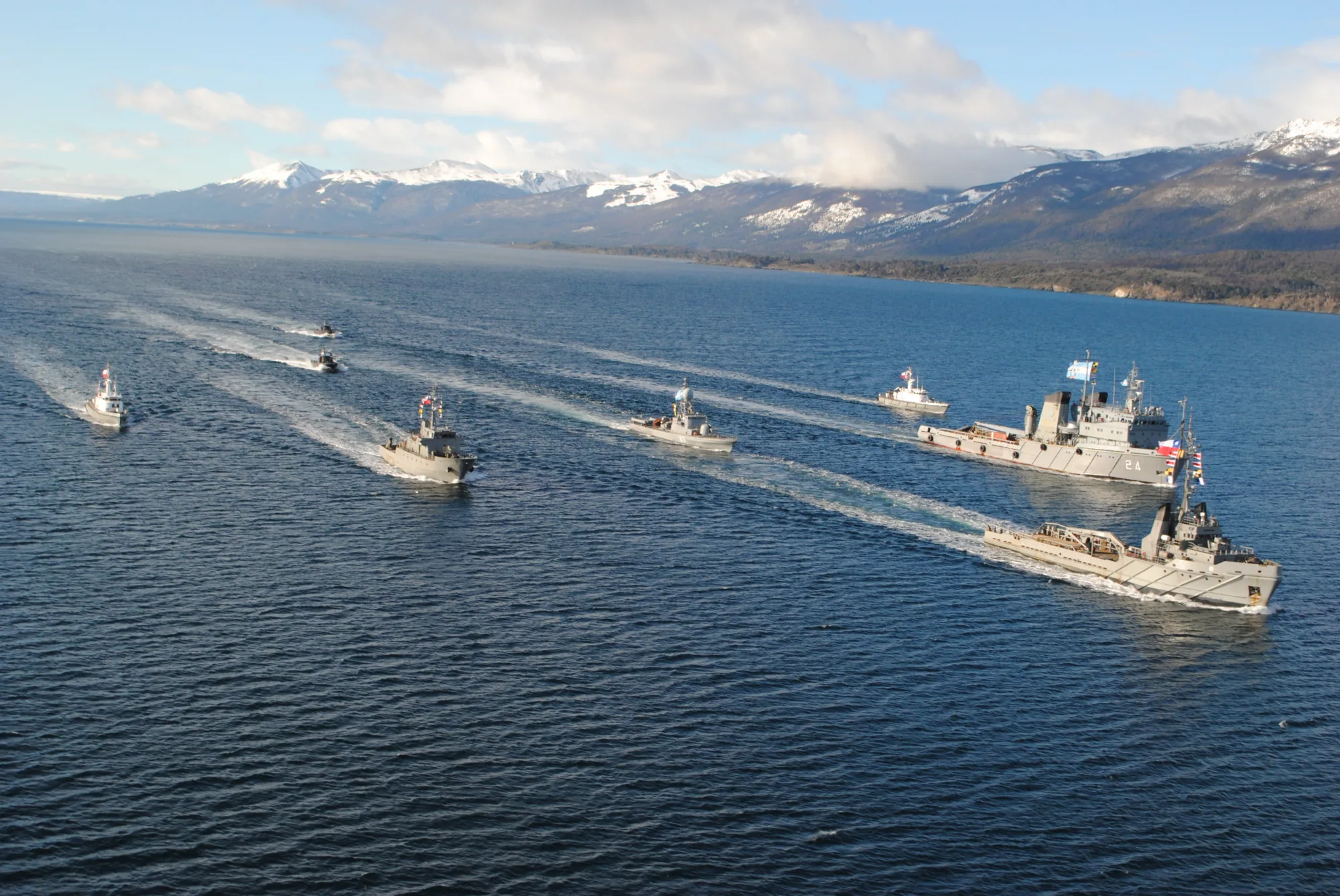 Formación aérea con varias unidades entre las que destaca el ARA Islas Malvinas (A-24); lanchas rápidas argentinas ARA Intrépida (P-85), ARA Clorinda (P-63) y ARA Baradero (P-61); unidades chilenas ATF Lautaro, PSG Isaza (PSG-73), LSG Alacalufe (LSG-1603) y LSG Hallef (LSG-1604); en el Canal Beagle durante el ejercicio combinado Viekaren XVI de 2016. Créditos: Armada Argentina.